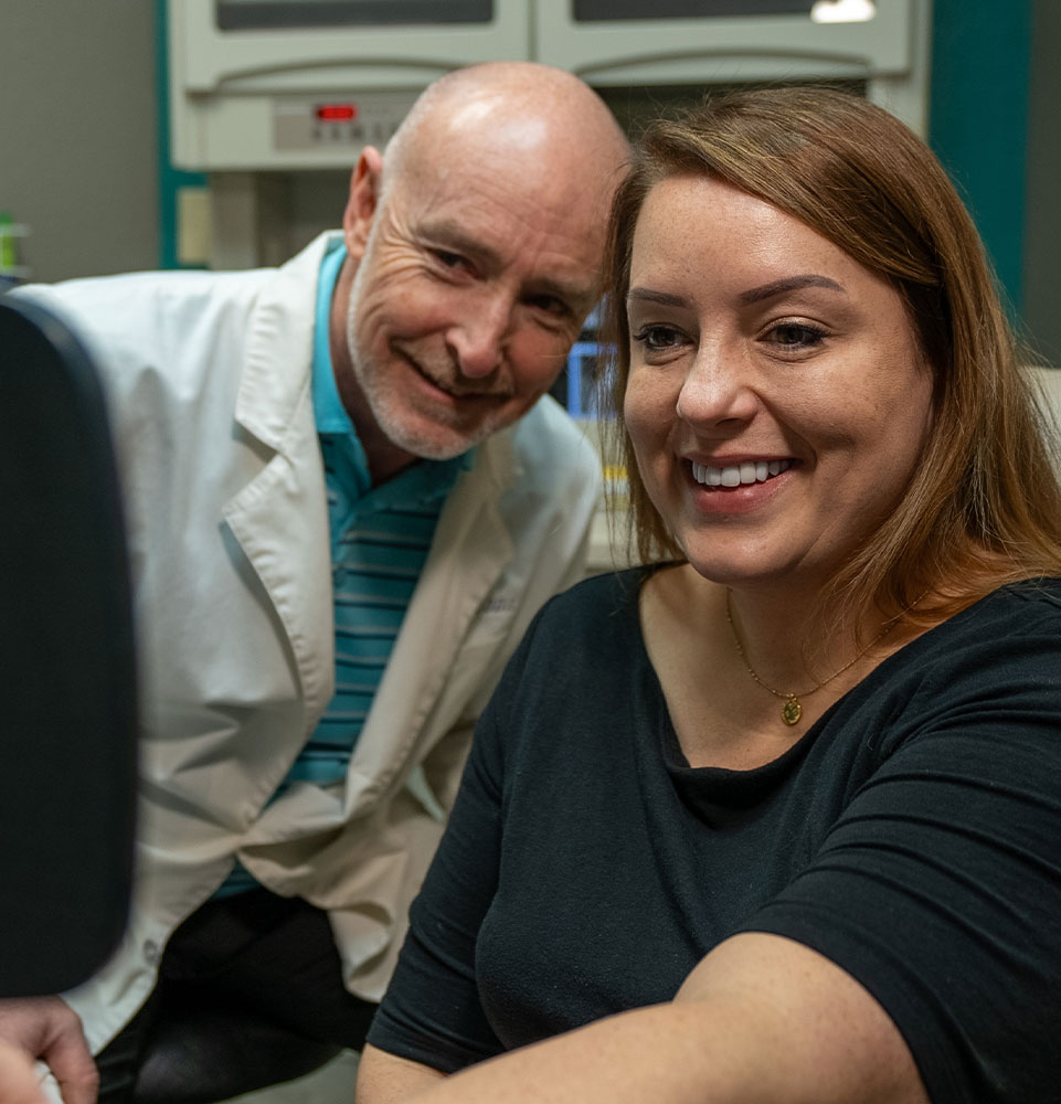 candice with dr burke after looking at smile makeover