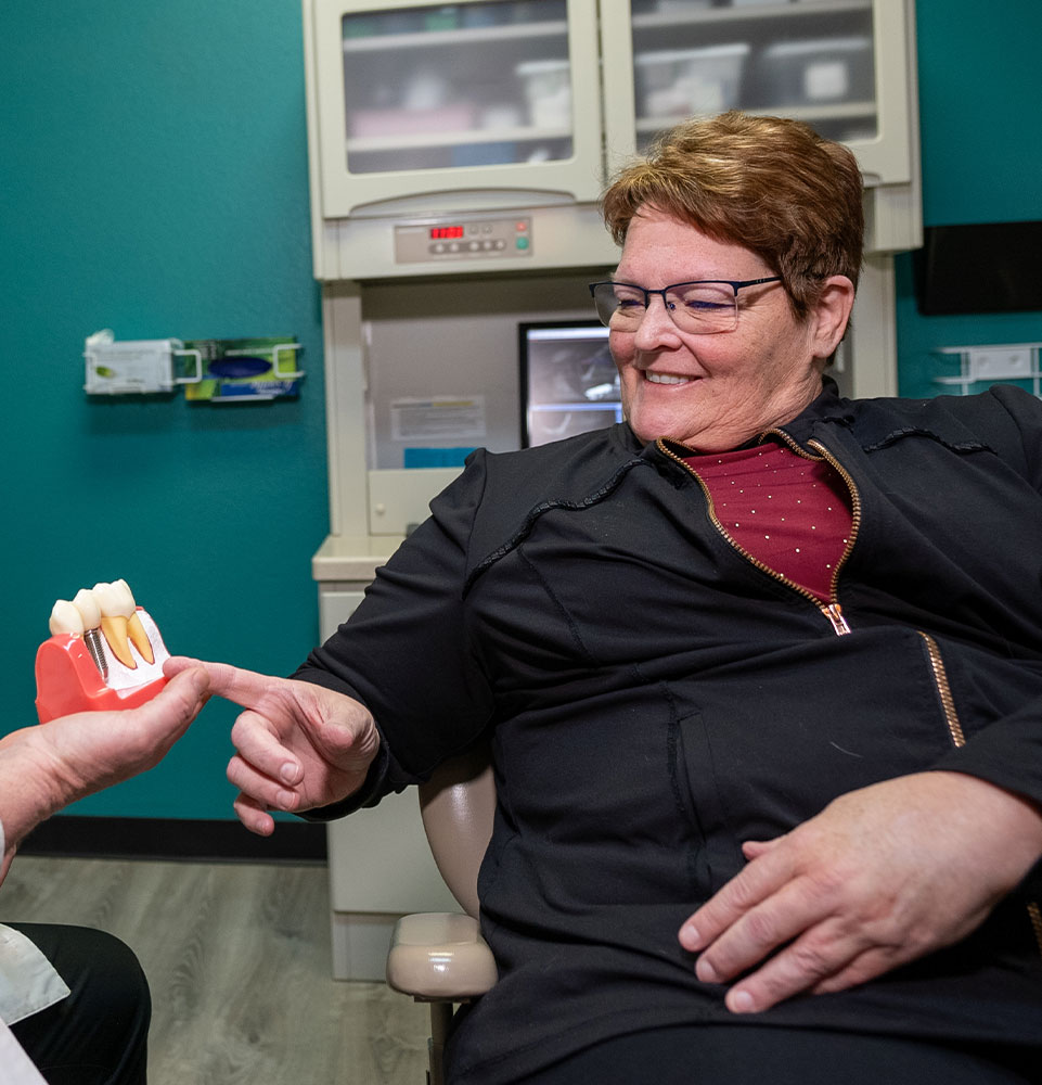 dr burke with cindy point dental implant mobile